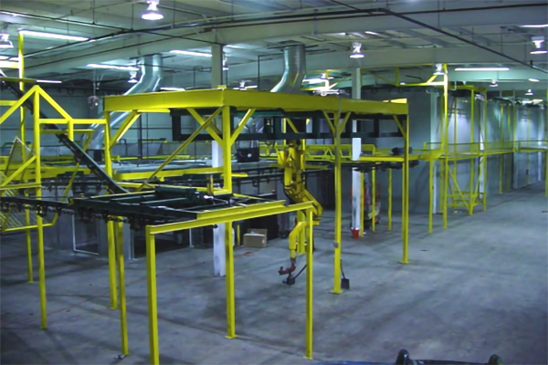 Turnkey industrial powder coating system with integrated washer, booth, and cure oven